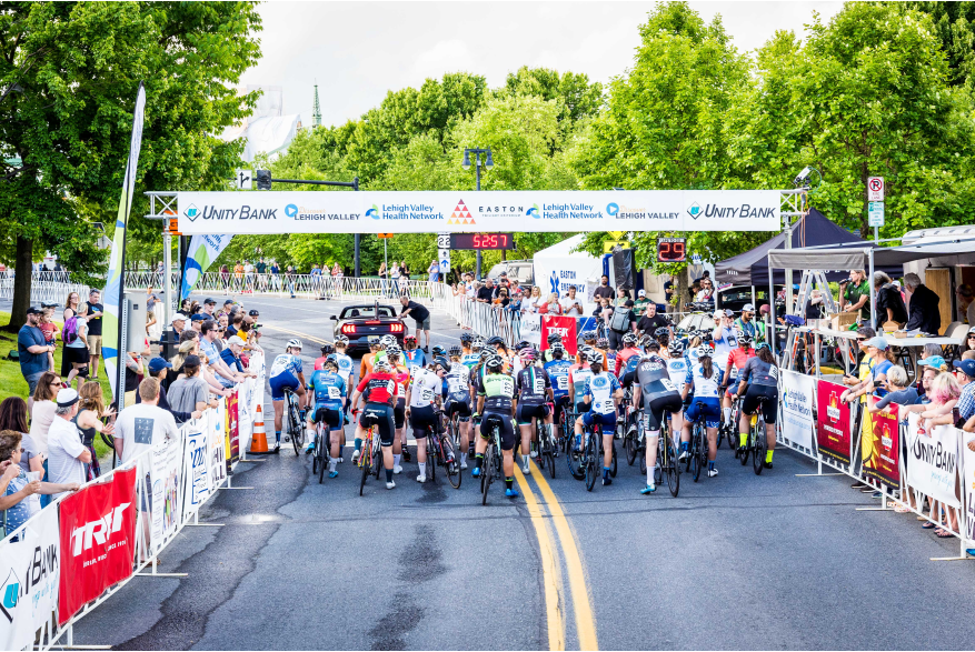 Cyclists line up at the starting line of the 2022 Easton Twilight Criterium in Easton, Pa.