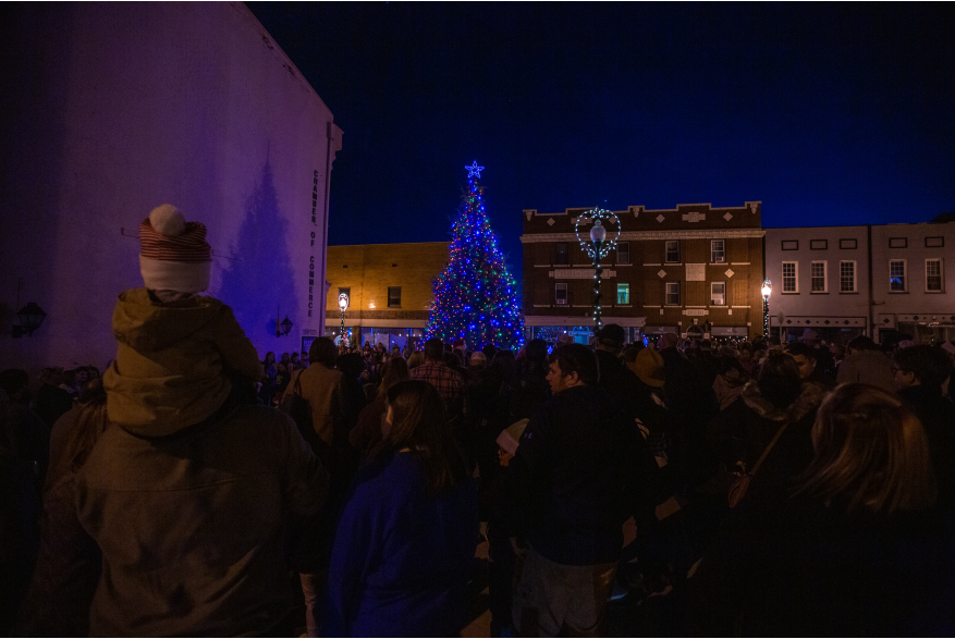 people gathered on the street in front of the christmas tree on walker square for light up downtown
