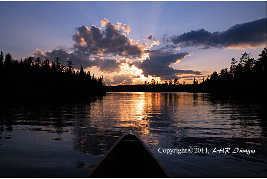 blue canoe at sunset