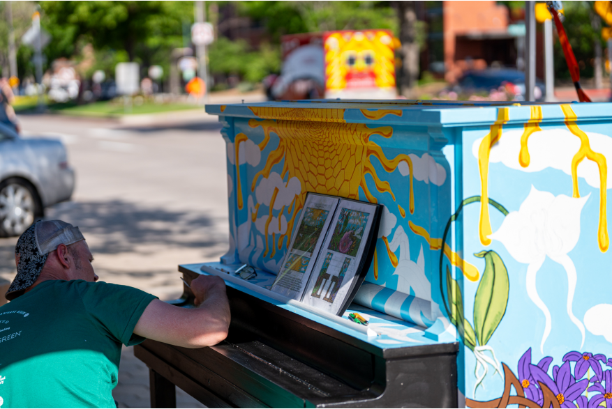 Man painting piano