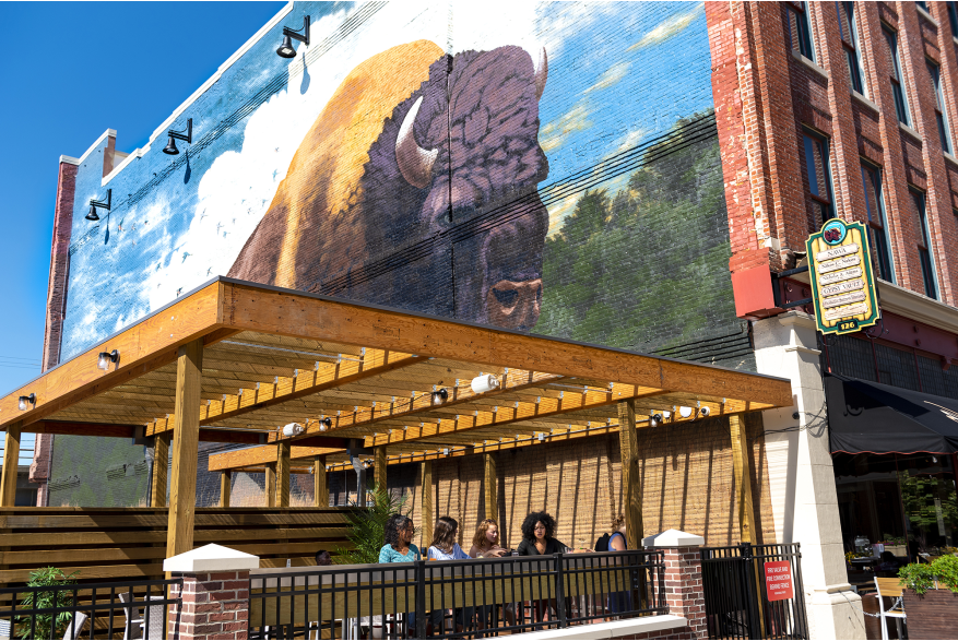 Friends dining on the outdoor patio deck at Nawa on The Landing