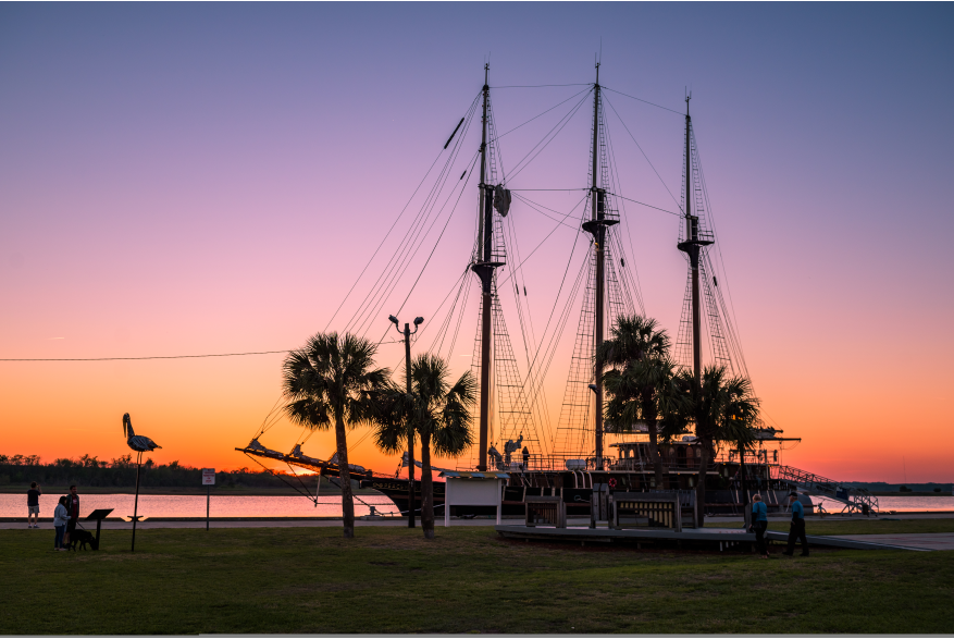 Sunset behind boat at Mary Ross Waterfront Park in Historic Downtown Brunswick, Georgia
