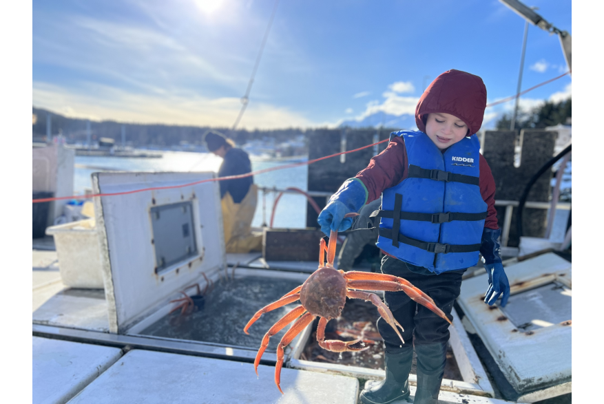 Lucas DeWitt with a tanner crab onboard the F/V Kealailani