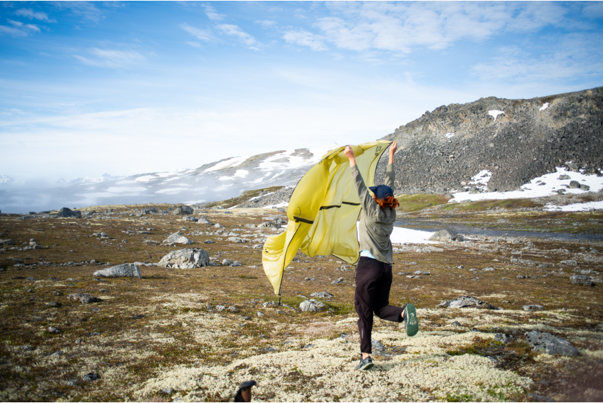 summit view women drying out rain fly by blowing in the fresh air