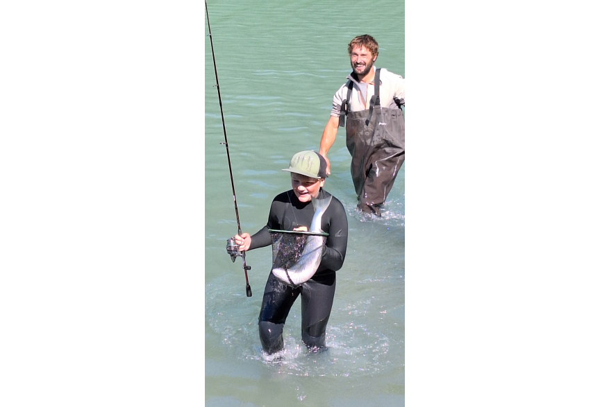 Father and son fishing, salmon in net, chilkoot lake