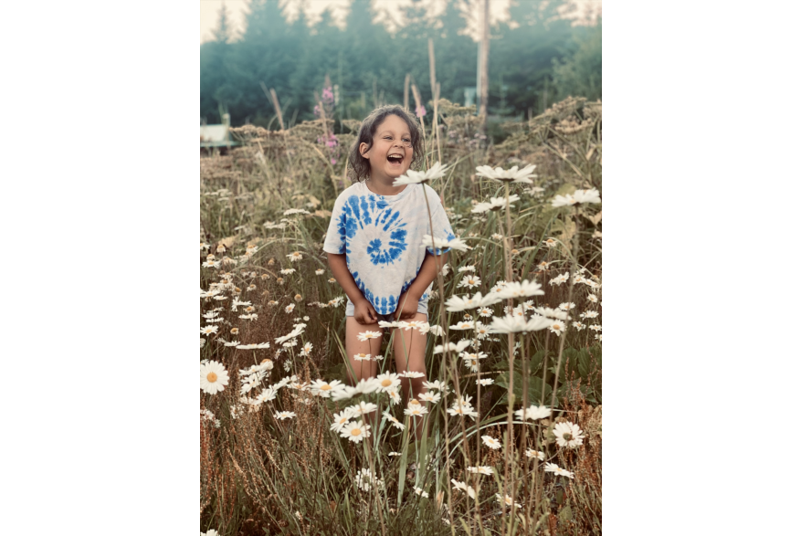young girl in field of daises