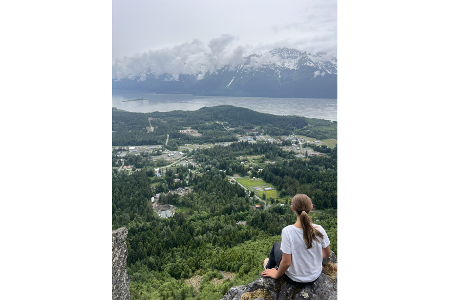 View of town of Haines from mountain top, girl over looking