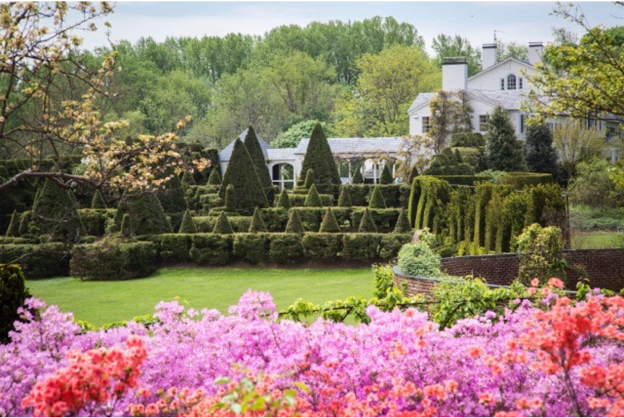 The Main House at Ladew Topiary Gardens with beautiful flowers and topiaries in front of the house