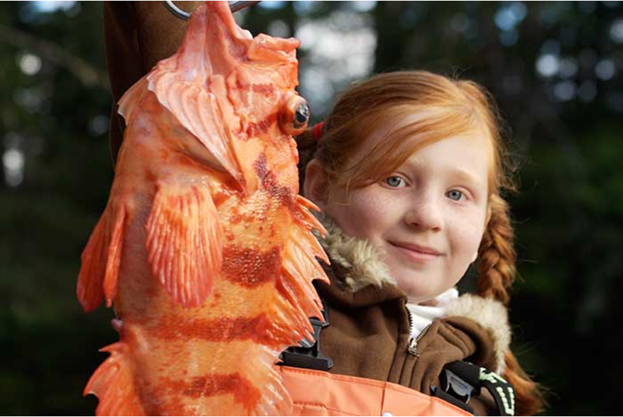 Girl holding a rock fish