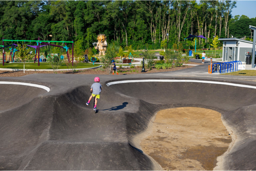 Kid scootering on pump track