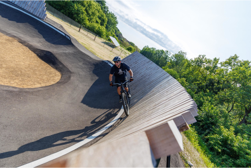 person riding wodden wall at pump track