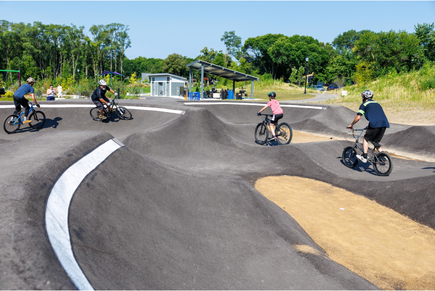 4 riders using the pump track