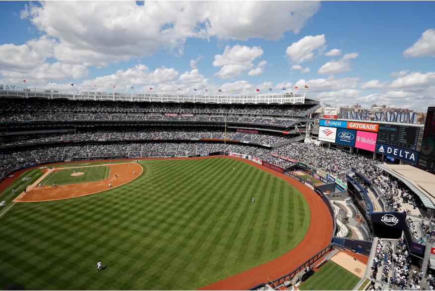 Angled view of Yankees Stadium with a clouded blue sky