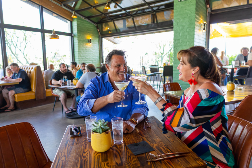 Couple toasting at 1501 Gastropub.