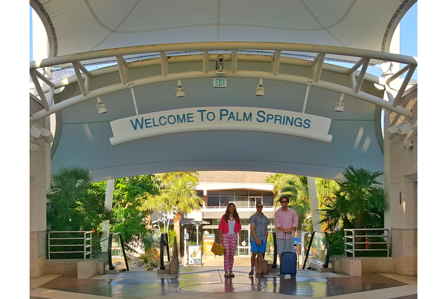 Three people walking to gate at PSP.