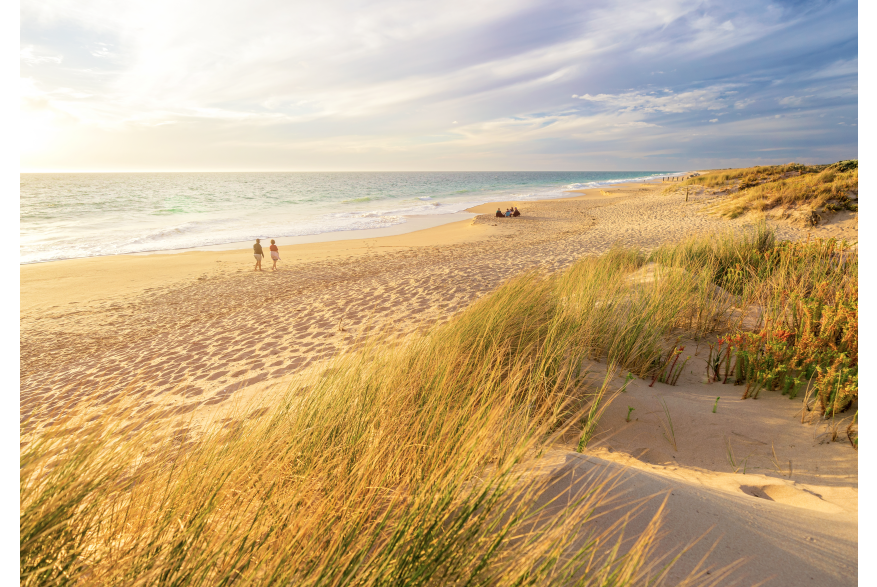 Couple walking along the sand at Preston Beach in Waroona