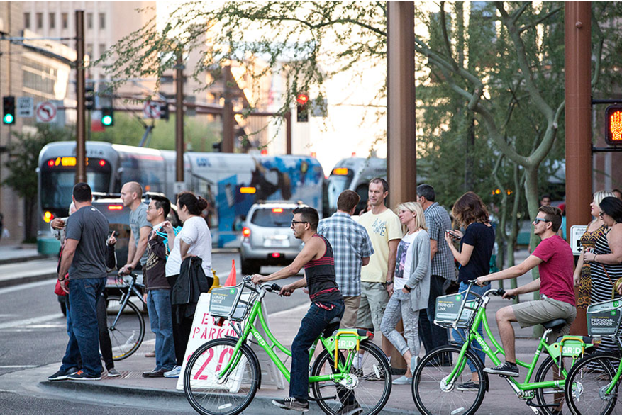 People Crossing A Street On Foot and Bikes In Downtown Phoenix, AZ