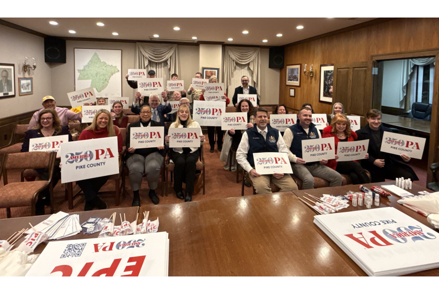 A group holding signs at Pike County's America250PA kick-off event