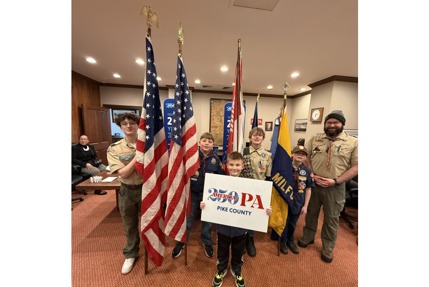 A group posing with the American flag at Pike County's America250PA kick-off event