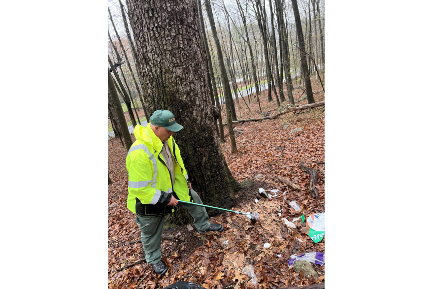A volunteer picking up trash during Pick Up The Poconos
