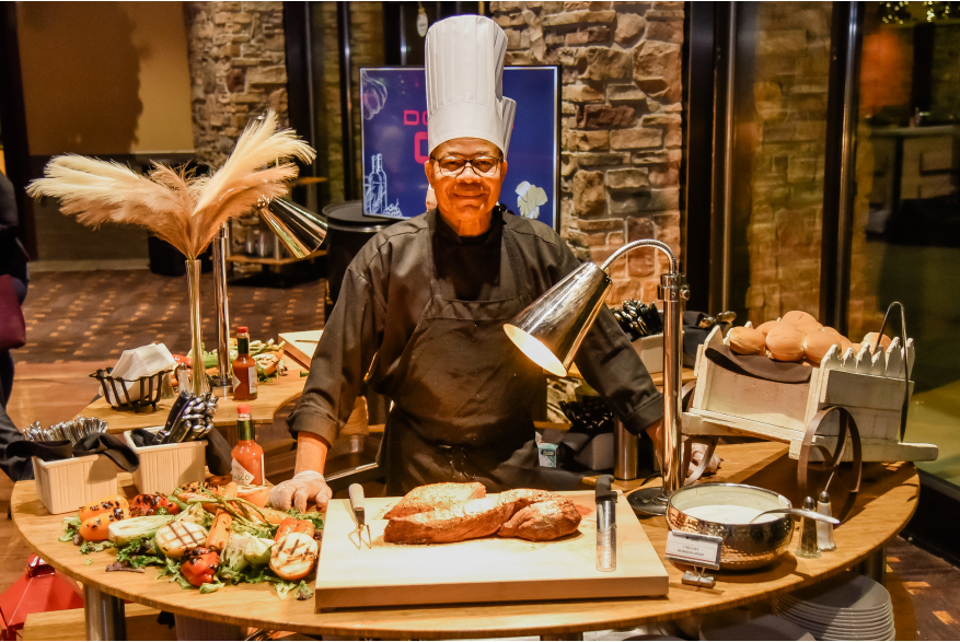 A chef posing with one of the dining options during the reception at More Front Doors: The Pocono Housing Summit