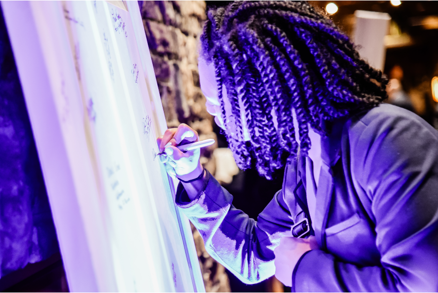 A women signing a door in support at More Front Doors: The Pocono Housing Summit