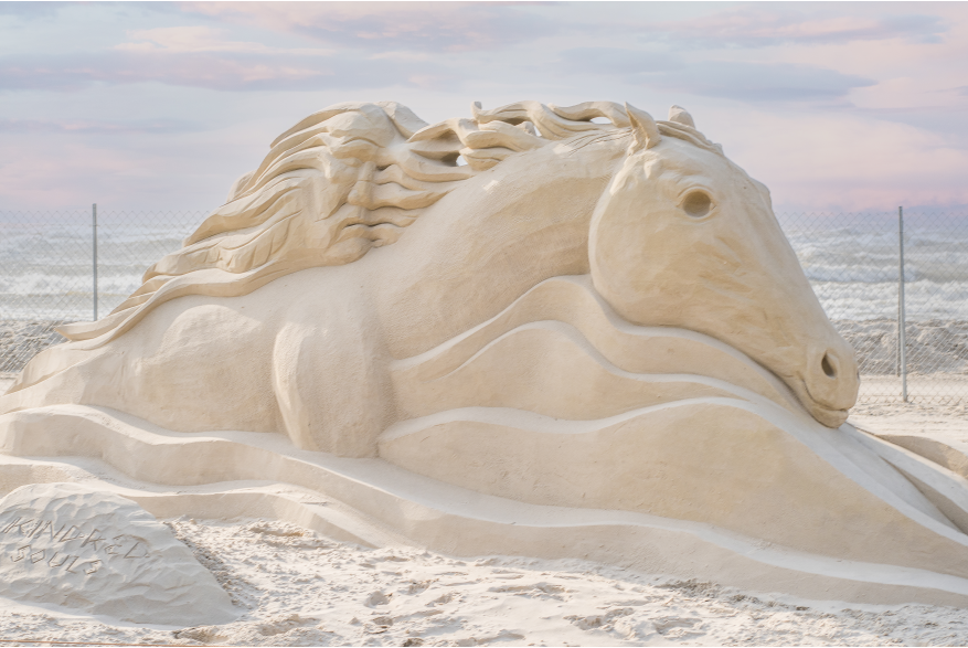 Large horse sculpture made of sand.
