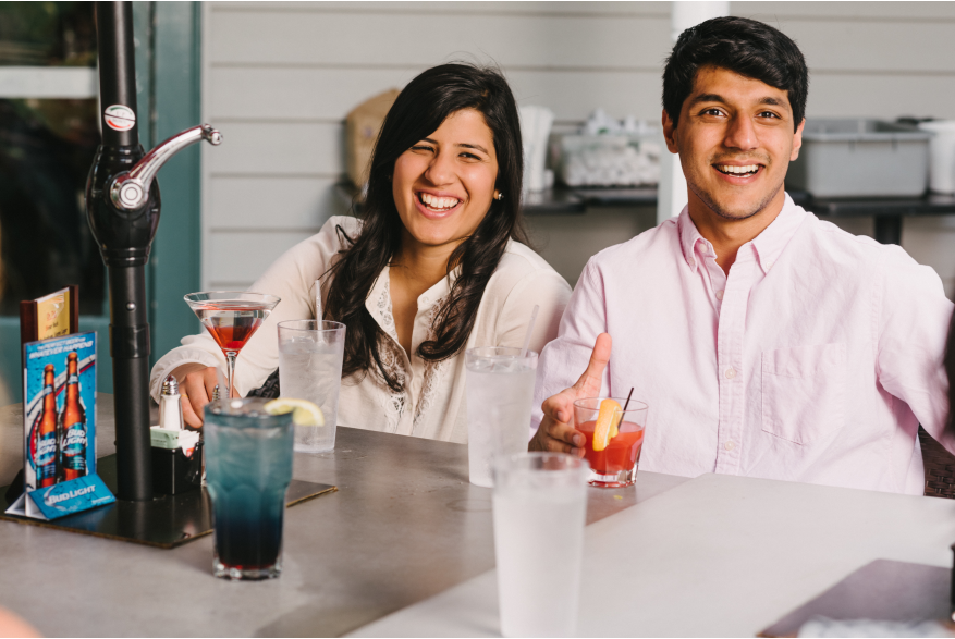 A woman and a man sitting at a table smiling
