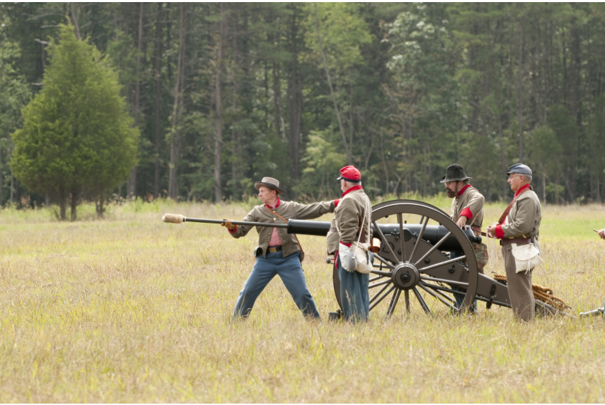 Men loading a cannon, civil war reenactment