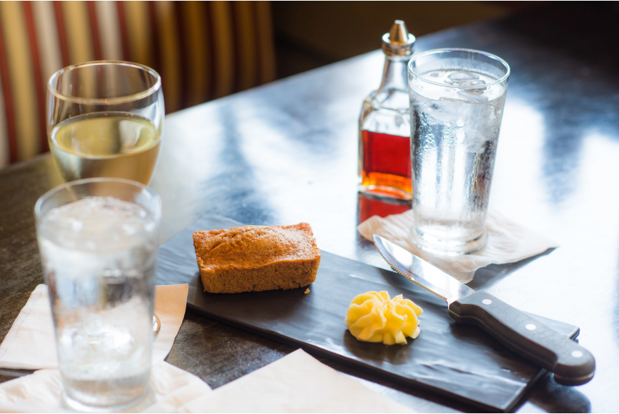 Glasses, bread and butter on a table