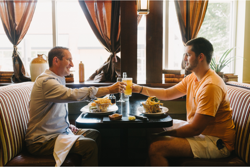 Two people sitting at a table having a meal