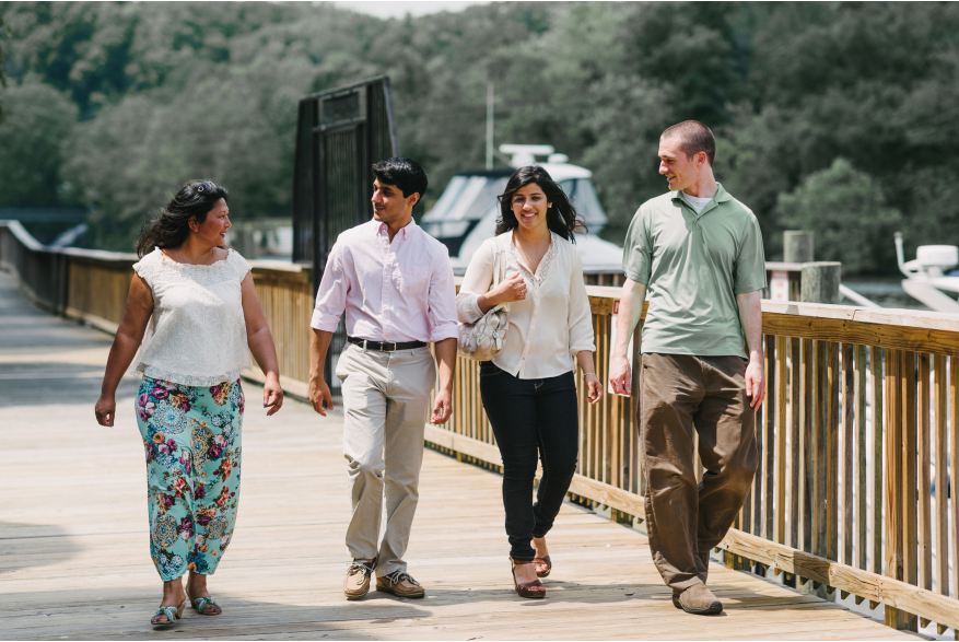 Two women and two women walking along a bridge