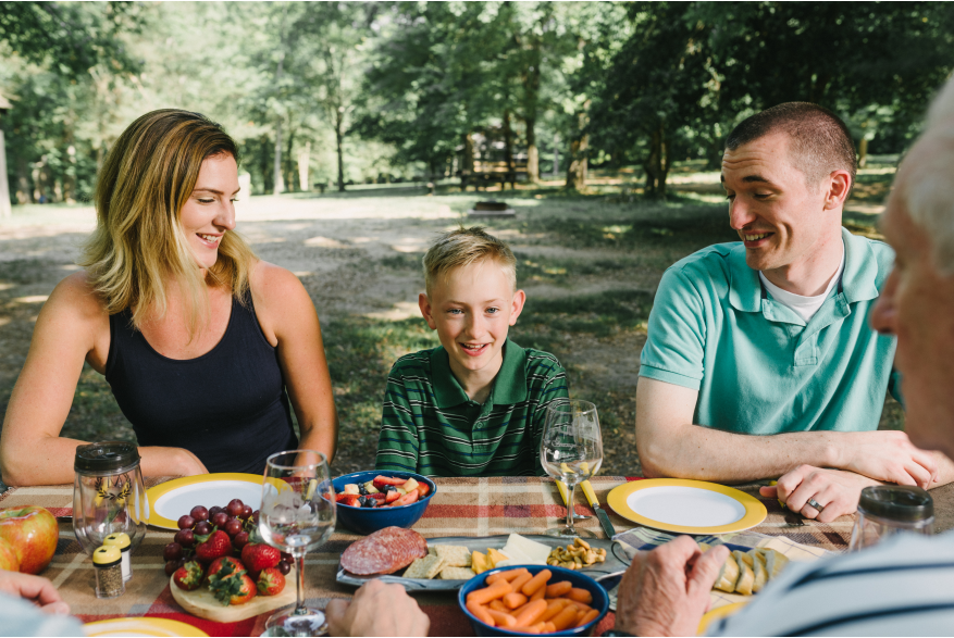 A family sitting together at a picnic table