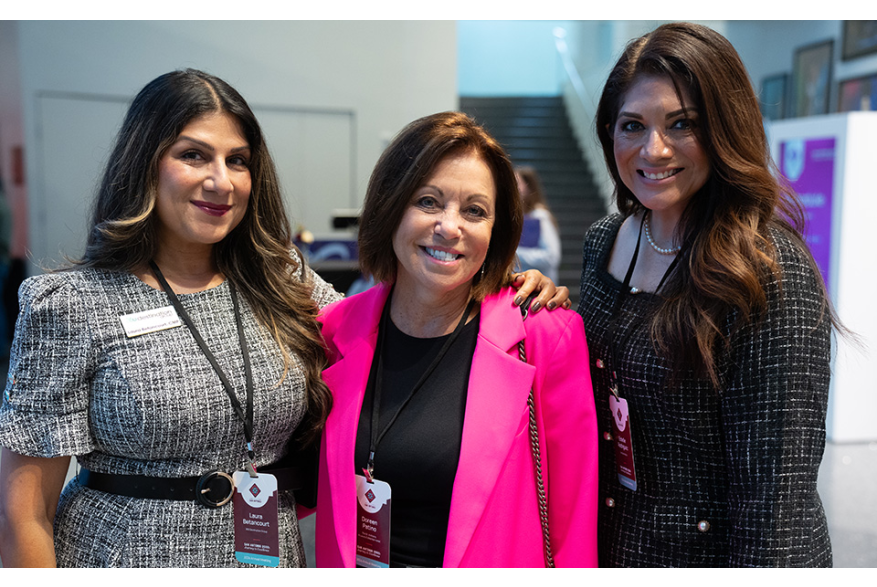 3 women professionals at conference