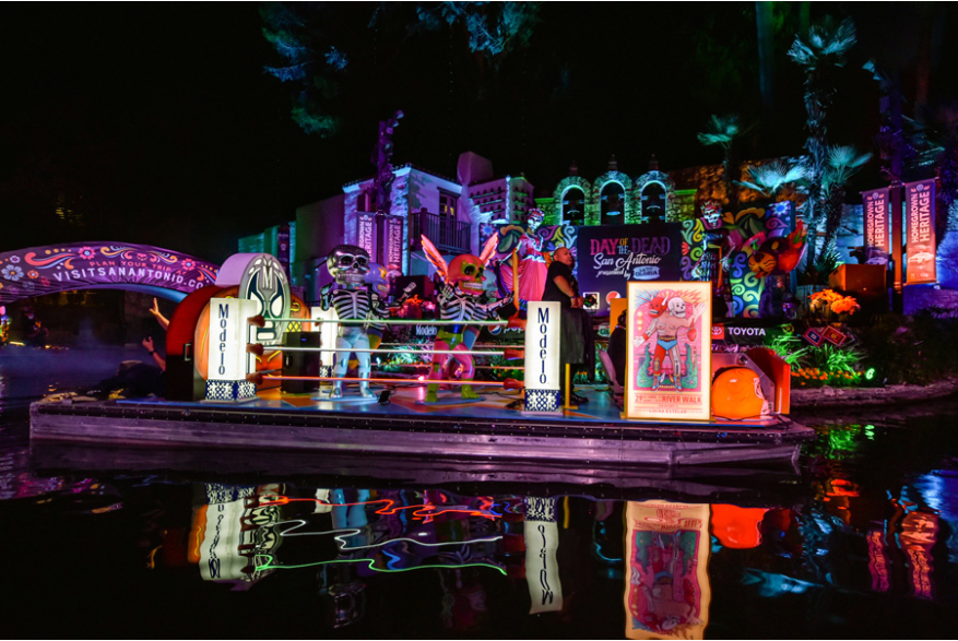 River parade at night with Dia de los Muertos decor