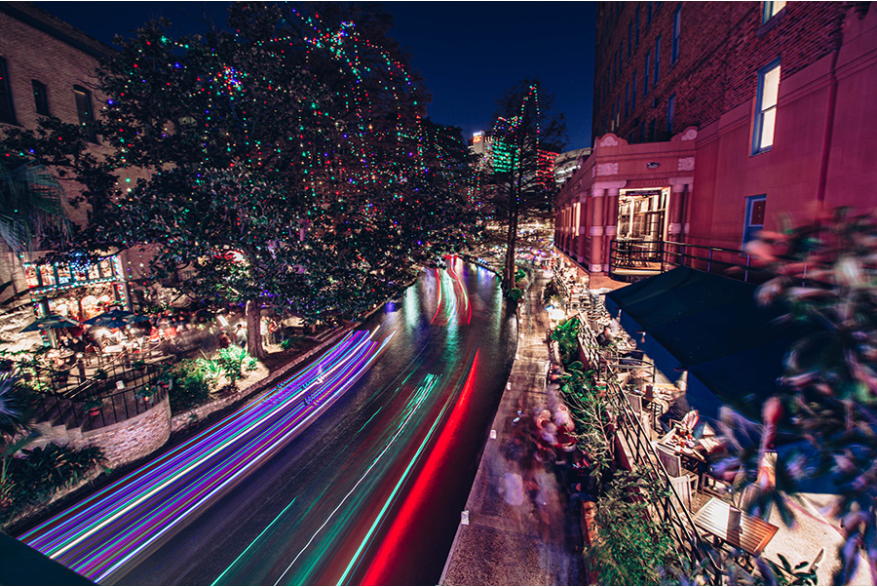 River Walk with holiday lights and glow from river barge