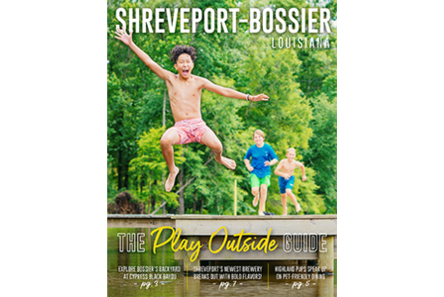 Young boys jumping off a pier into a lake