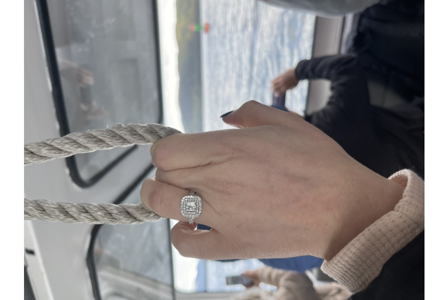 Photo of diamond engagement ring on woman's hand