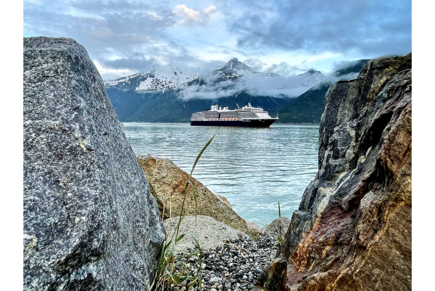 sneak peek at ships arrival through rock on beach