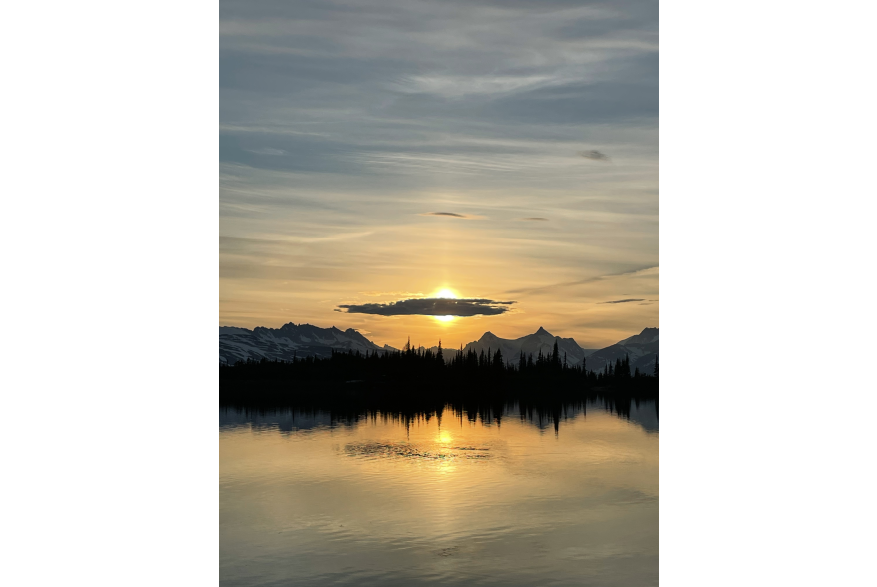 The sun behind a cloud with the mountains west of Skagway in the background. Picture is taken from the east side of Upper Dewey Lake, looking west.