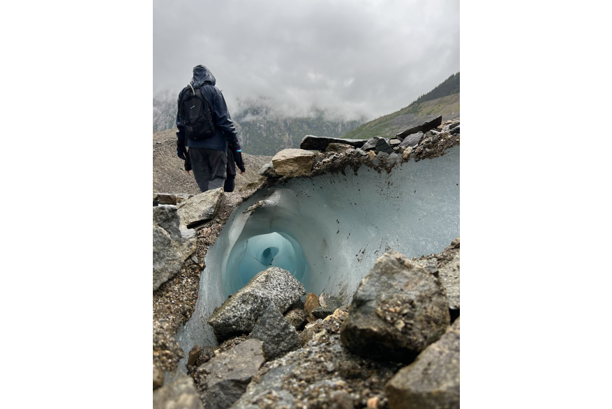 This photo was taken on Denver glacier. I took the perspective of this hole that went all the way down to the bottom of the glacier and for a contrast of size my person subject I asked to walk by.