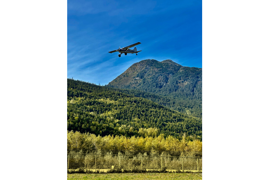 PLANE FLYING PAST AB MOUNTAIN