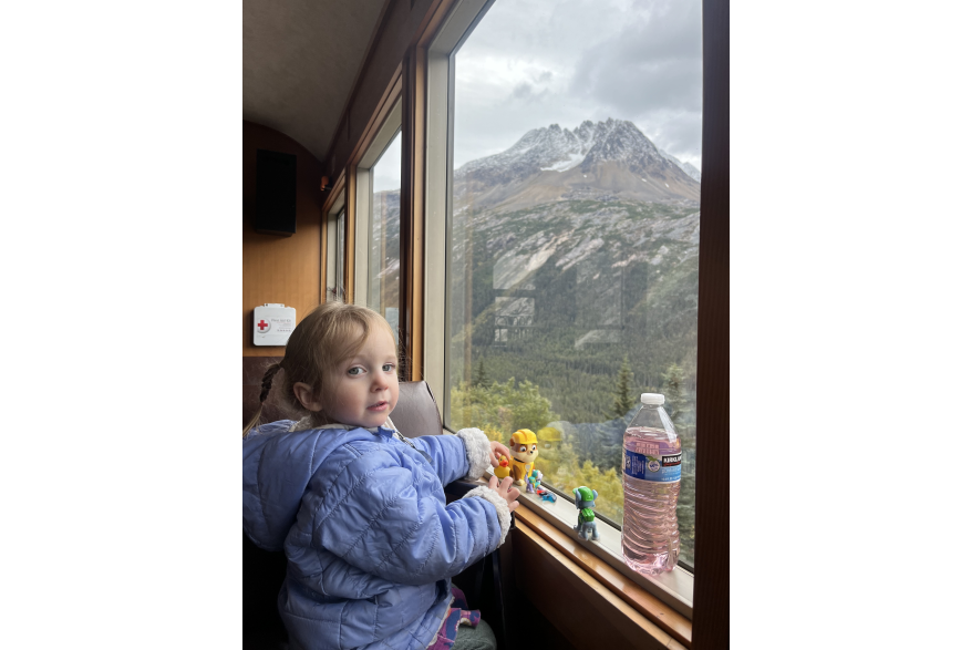 Lucy, age 2, enjoys a train ride with her mom to see her dad, the conductor