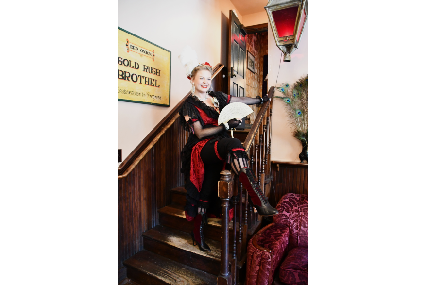 A "madam" escorts guests on a "quickie" tour of the Red Onion Saloon Brothel Museum.