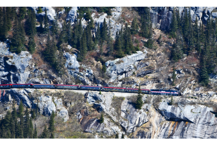 As I traveled on the White Pass & Yukon Route, the "twin" train was heading in the other direction, a testament to the beauty and rugged terrain of this railway route.