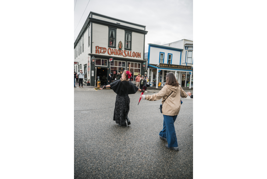 Madame Trixie Turner leads a street walking class to the red Onion on Broadway.