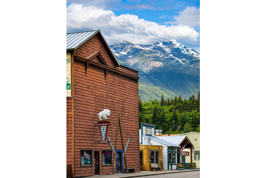 Title: Where History Meets the Mountains Historic Skagway sits beneath the towering peaks of Alaska’s Coast Mountains, where Gold Rush history meets breathtaking wilderness. As the clouds lifted, the landscape revealed the timeless beauty that makes this remarkable town unforgettable.