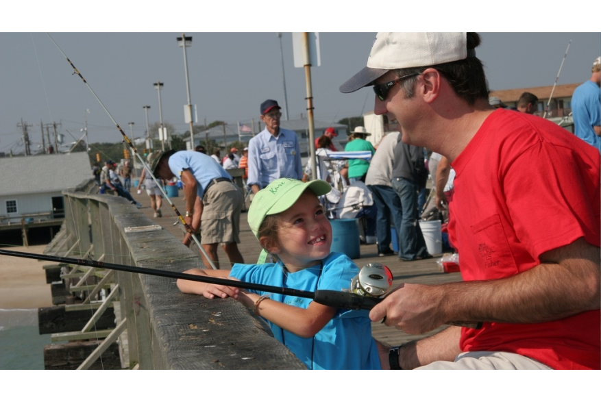 Father and daughter fishing off the Kure Beach Fishing Pier