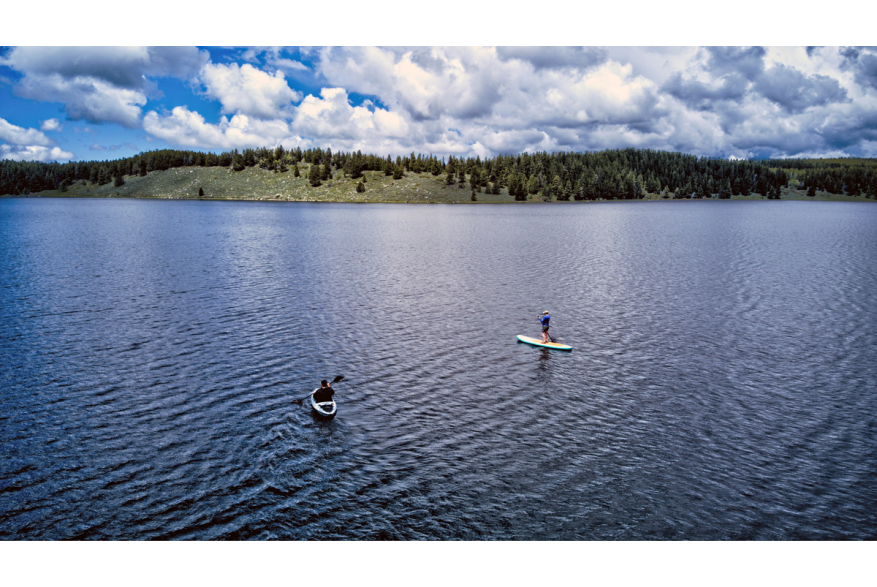 two paddle boarders on a lake