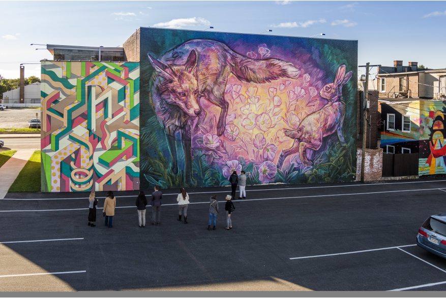 a group of people admiring a mural at Mural Park in the Royal Square District of Downtown York